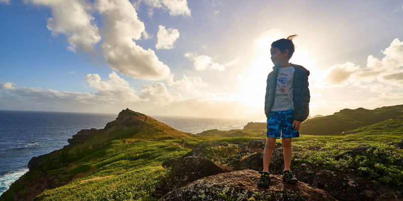 Kid standing on rock
